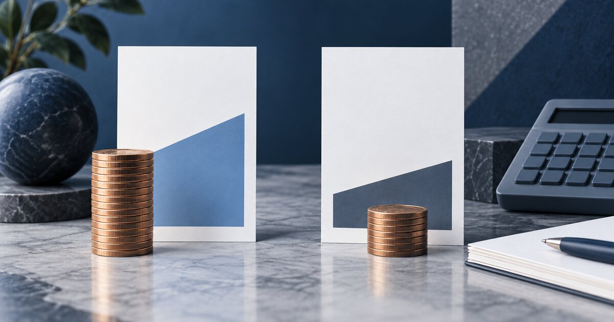 Two abstract comparison cards, coins, and a calculator on a blue and white desk